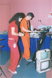 Seth Sternburger (in orange) and his assistant play SID music