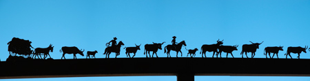 Silhouettes of ranching activities at an exhibit near Baker